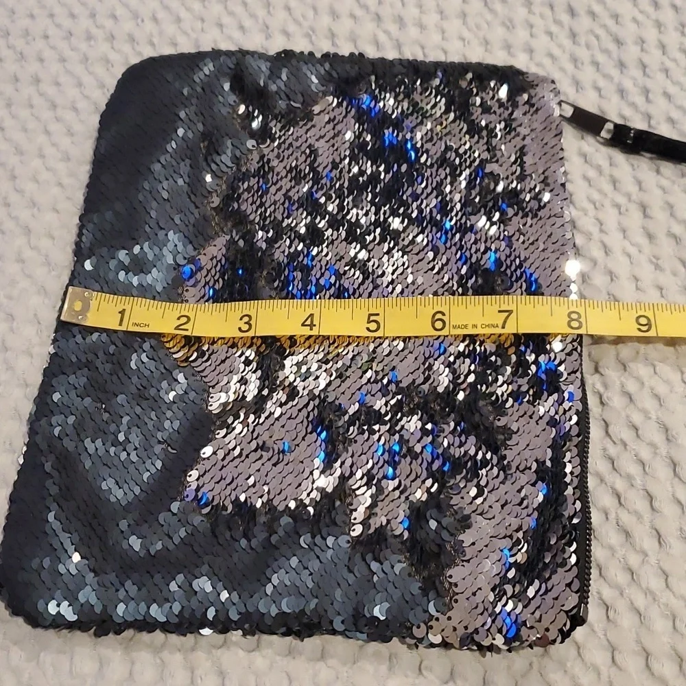 NWOT Cheekys brand color changing sequin wristlet. Changes from silver to black